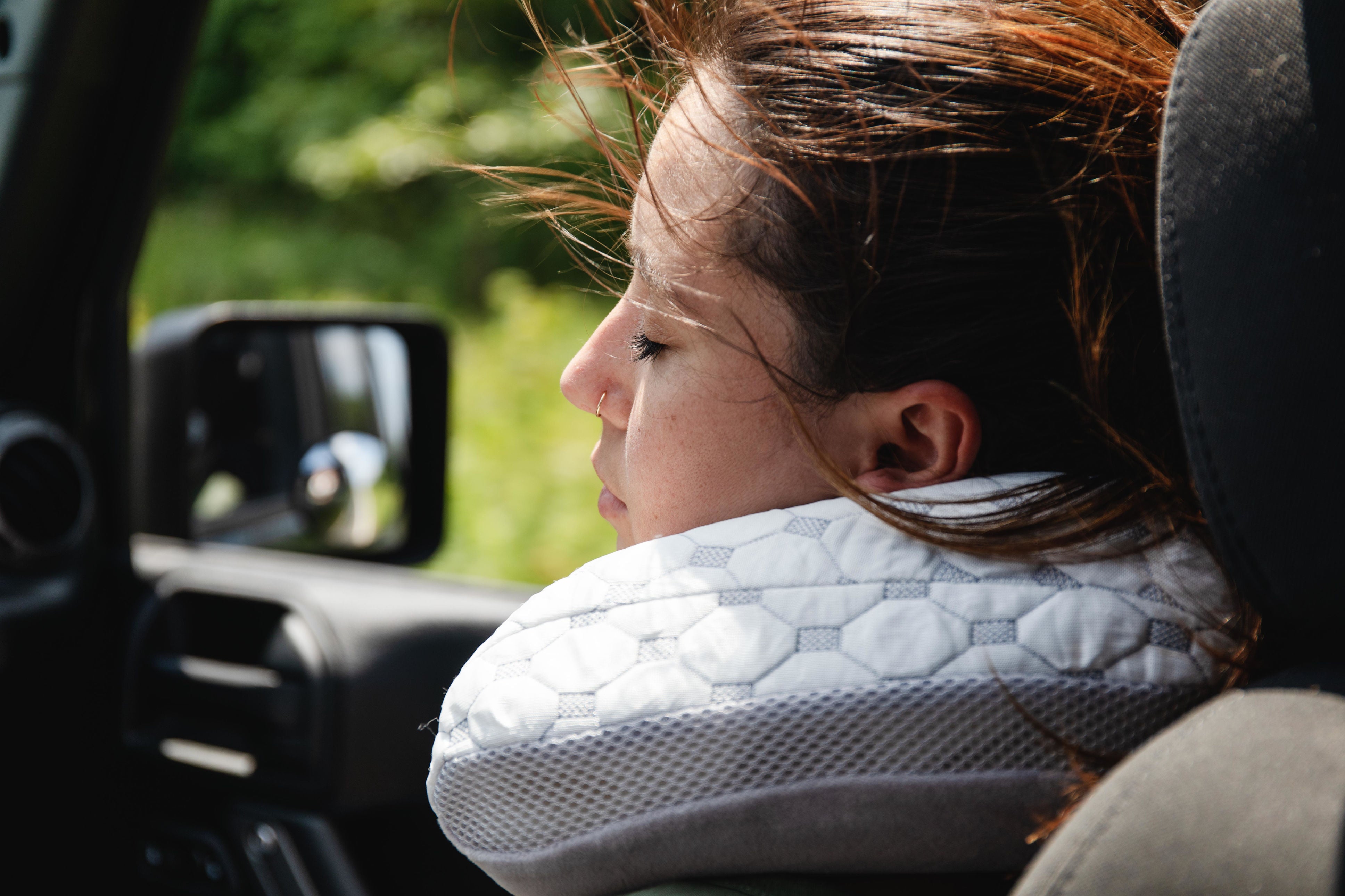 woman with muse travel pillow driving compressed